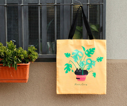 Tote bag in canvas di cotone stampato - Meowstera, un paffuto gatto nero seduto su una pianta di Monstera